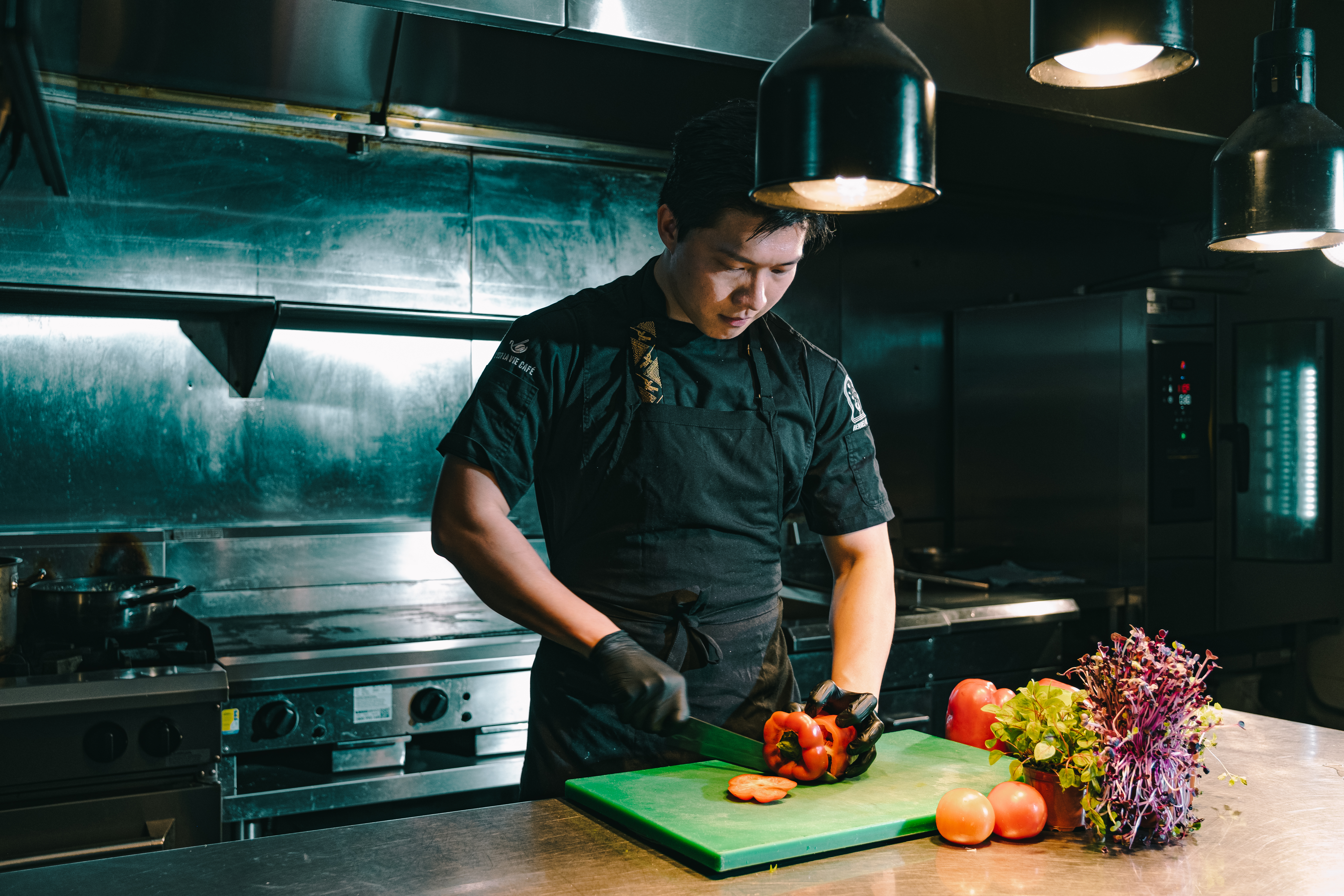 A graphic shows a man cooking in a modern kitchen