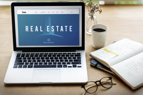 Homebuyer searching real estate listings online with laptop